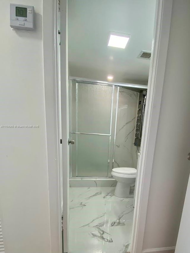 full bathroom featuring a stall shower, marble finish floor, visible vents, and toilet