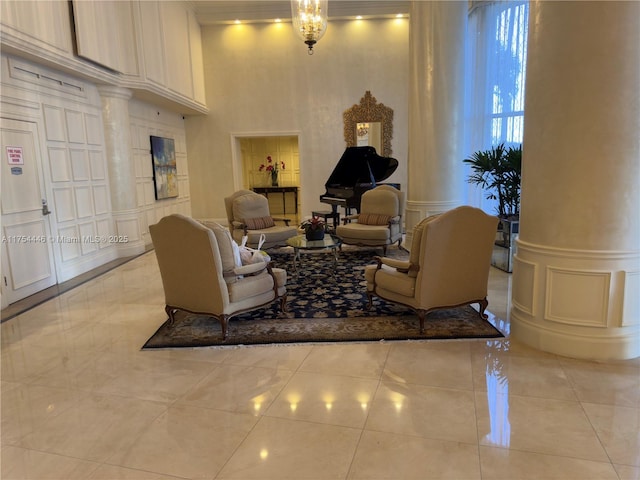 living area featuring light tile patterned floors, a wainscoted wall, and a decorative wall