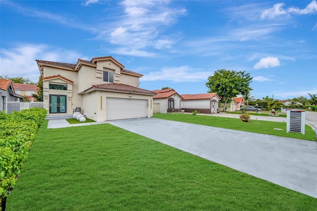 mediterranean / spanish home with a front yard, french doors, concrete driveway, and stucco siding