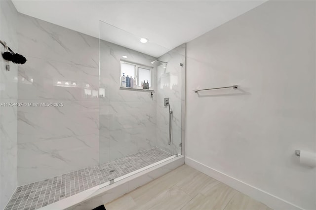 full bathroom with baseboards and a marble finish shower