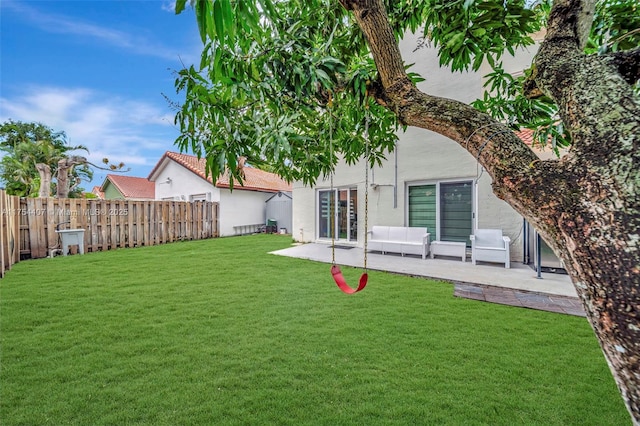 rear view of house with a patio area, a fenced backyard, a yard, and stucco siding