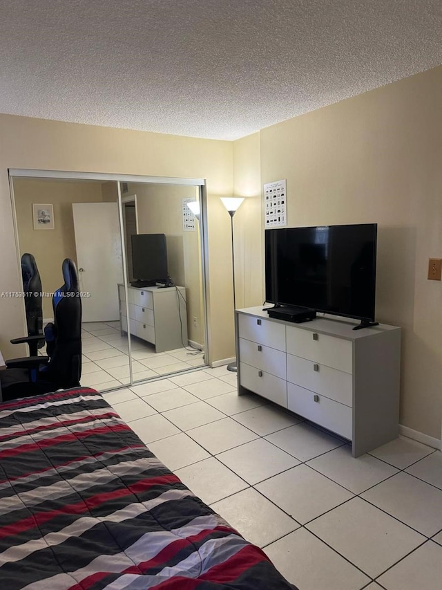 300 NW 107th Ave Unit 106, Miami, FL 33172 - bedroom featuring baseboards, a textured ceiling, and light tile patterned floors