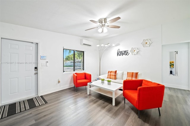 living room with ceiling fan, baseboards, wood finished floors, and a wall mounted AC