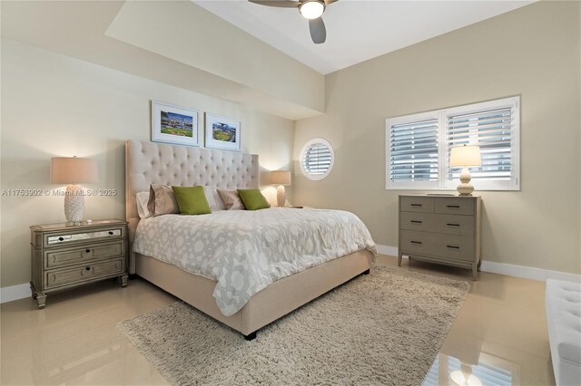 bedroom with a ceiling fan and baseboards