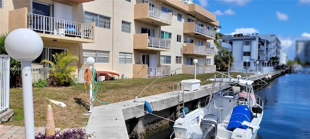 view of dock featuring a water view and fence