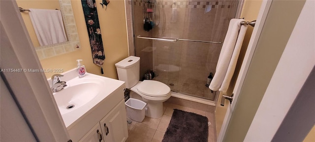 bathroom with toilet, a stall shower, vanity, and tile patterned floors