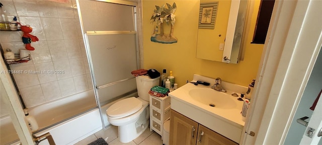 bathroom featuring bath / shower combo with glass door, vanity, toilet, and tile patterned floors