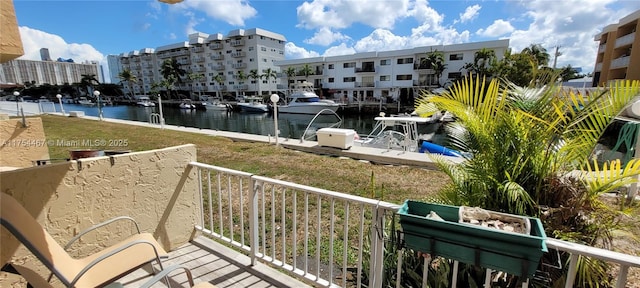 balcony with a water view and a boat dock