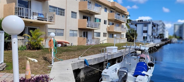 view of dock with a residential view and a water view