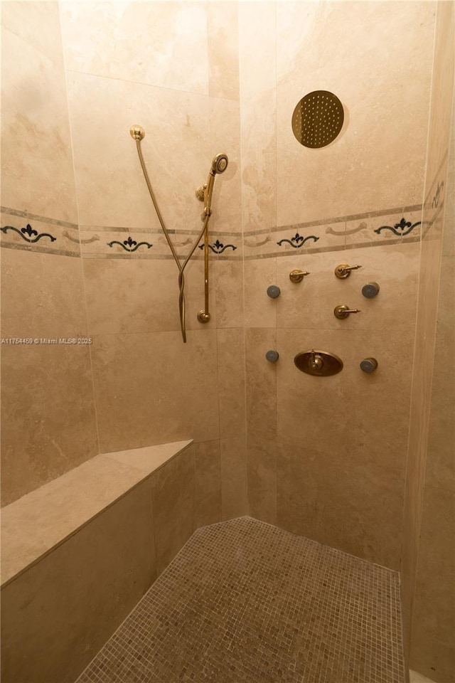 bathroom with tiled shower