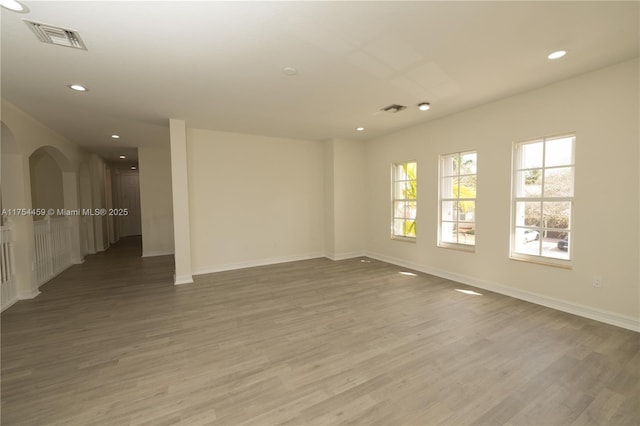 spare room featuring recessed lighting, visible vents, and wood finished floors