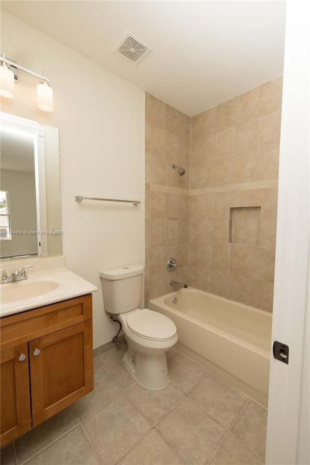 bathroom featuring toilet, shower / bath combination, vanity, visible vents, and tile patterned floors