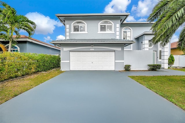 view of front of house featuring a garage, driveway, and stucco siding