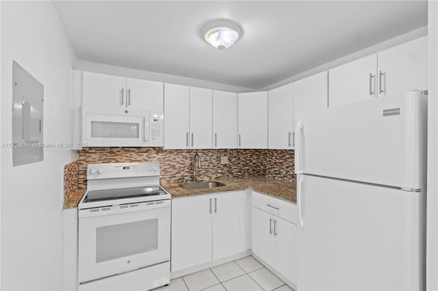 kitchen featuring white appliances, backsplash, a sink, and white cabinets