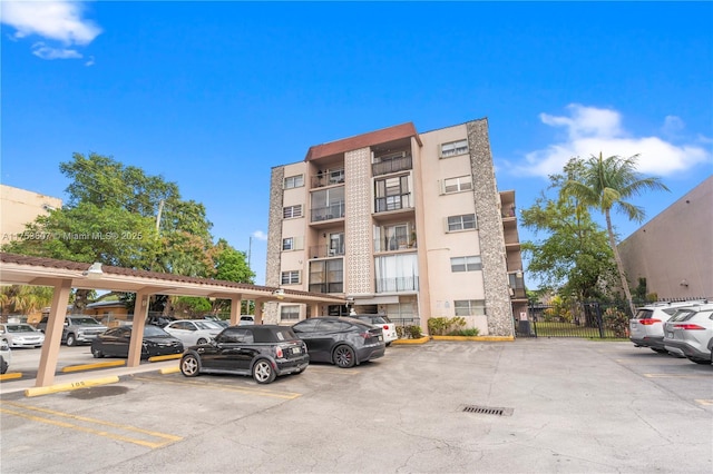 view of building exterior with uncovered parking