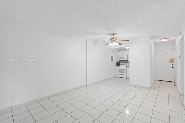 unfurnished room with ceiling fan, a textured ceiling, and light tile patterned flooring