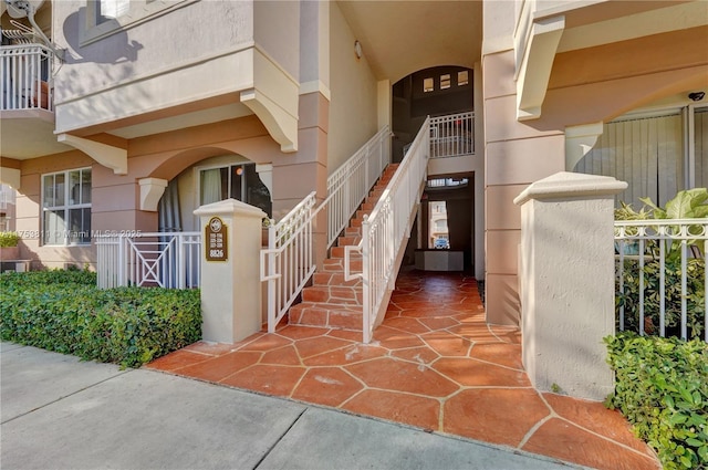 entrance to property featuring stucco siding