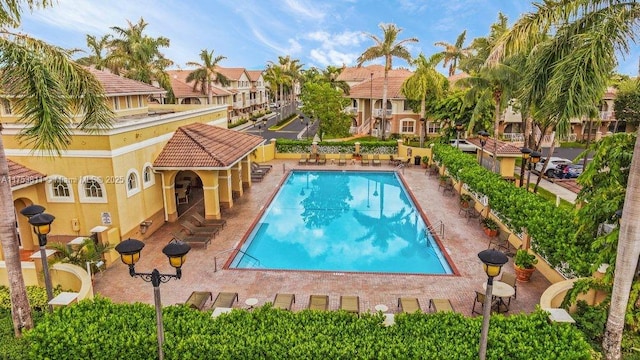 pool with a patio area and a residential view