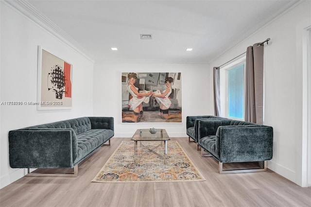 living room featuring baseboards, wood finished floors, visible vents, and crown molding