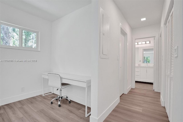 home office featuring baseboards and wood finished floors