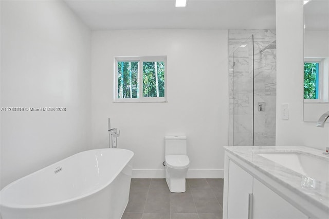 bathroom featuring a marble finish shower, a soaking tub, baseboards, and toilet