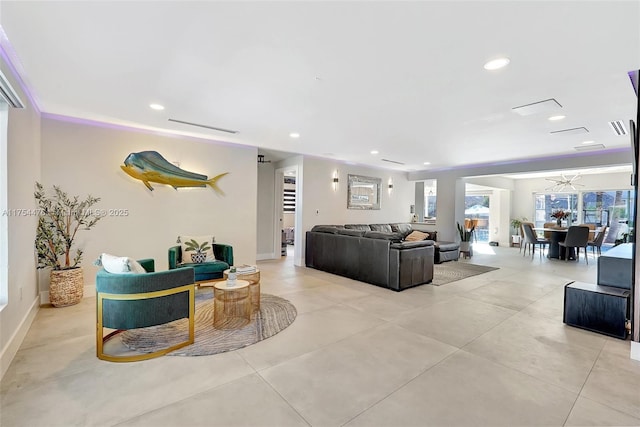 living area with baseboards, visible vents, and recessed lighting