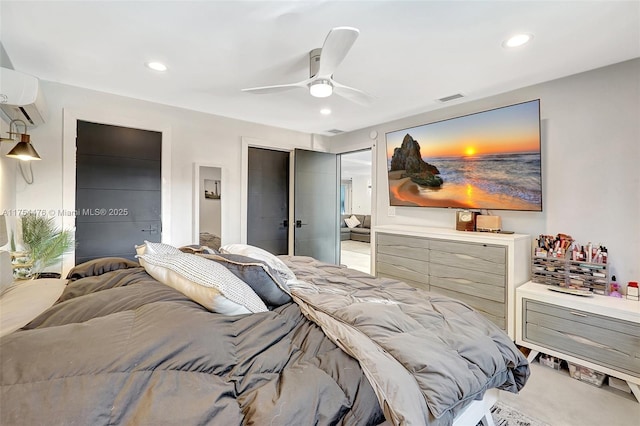 bedroom featuring an AC wall unit, two closets, visible vents, and recessed lighting