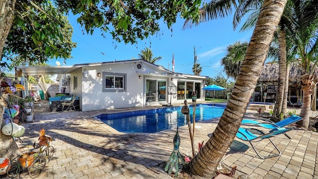 outdoor pool with a patio area and fence