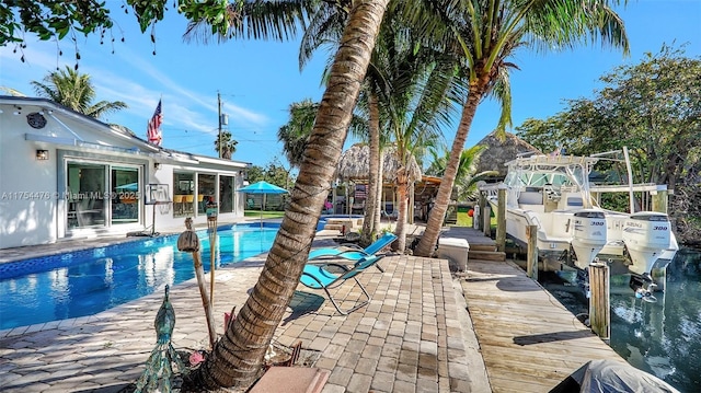 pool featuring a patio and a boat dock