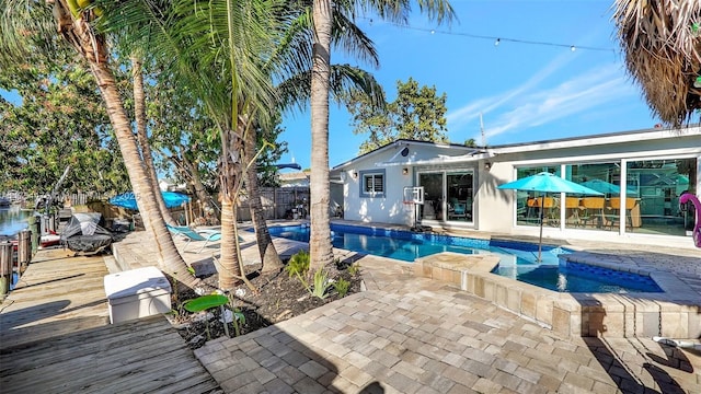 view of swimming pool featuring an in ground hot tub, a patio area, a fenced backyard, and a fenced in pool