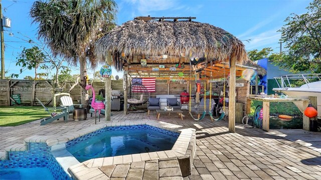 view of pool with an in ground hot tub, grilling area, a patio, and a gazebo