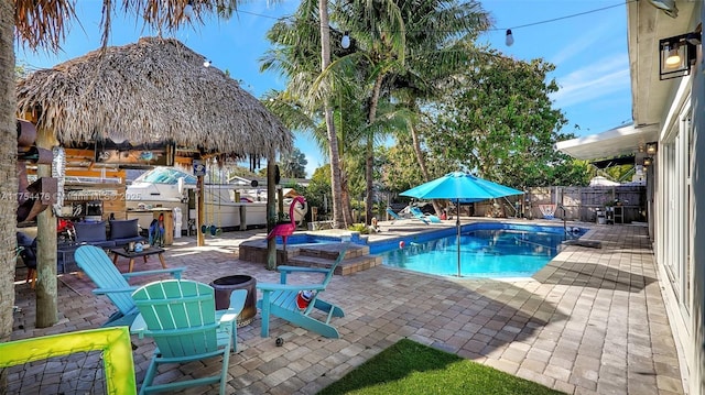 view of swimming pool with a patio area, a fenced backyard, and a pool with connected hot tub