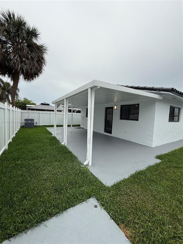 view of yard with central air condition unit and a fenced backyard