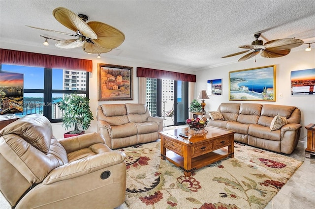 living room featuring a textured ceiling, ceiling fan, and crown molding