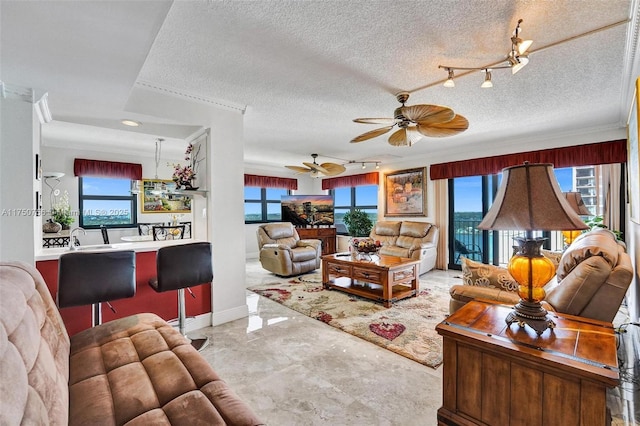 1201 S Ocean Dr Unit 1711S, Hollywood, FL 33019 - living area featuring a textured ceiling, ornamental molding, ceiling fan with notable chandelier, and a wealth of natural light