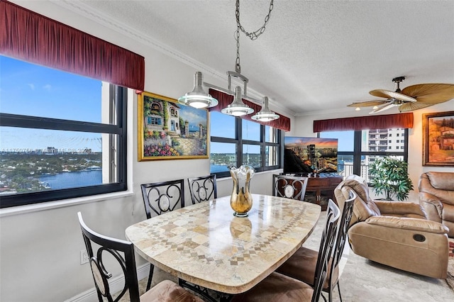 1201 S Ocean Dr Unit 1711S, Hollywood, FL 33019 - dining space with baseboards, a textured ceiling, a ceiling fan, and crown molding