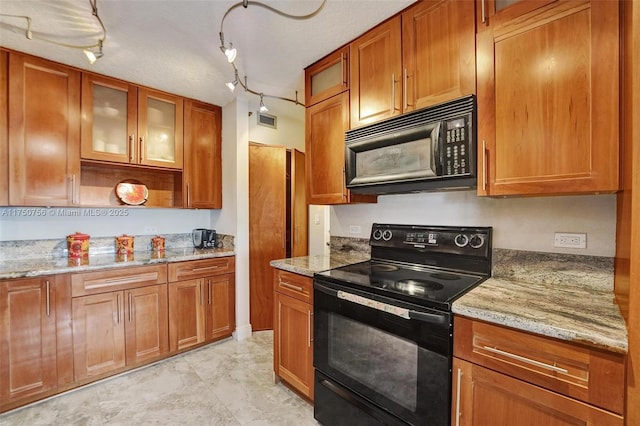 1201 S Ocean Dr Unit 1711S, Hollywood, FL 33019 - kitchen with brown cabinetry, visible vents, and black appliances