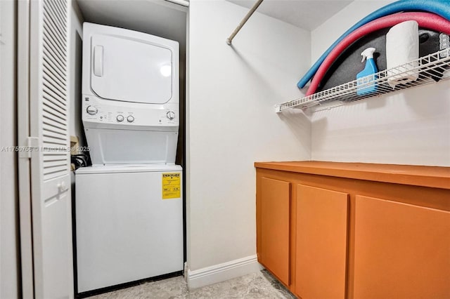 1201 S Ocean Dr Unit 1711S, Hollywood, FL 33019 - washroom with stacked washer and dryer, laundry area, and baseboards