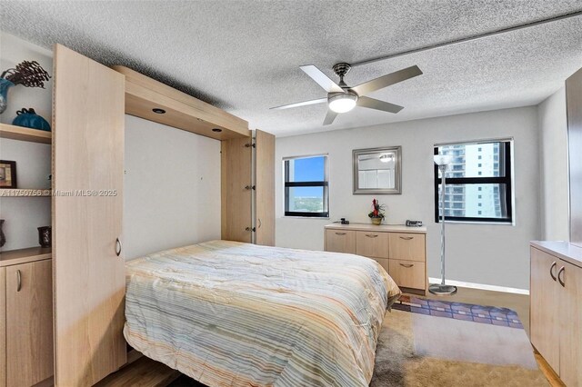 1201 S Ocean Dr Unit 1711S, Hollywood, FL 33019 - bedroom featuring a textured ceiling, ceiling fan, and baseboards