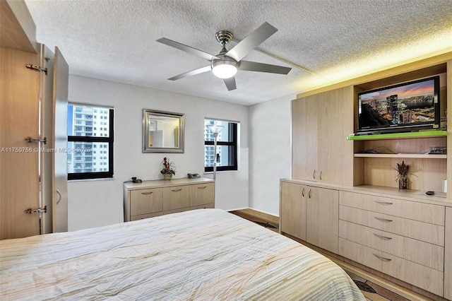 1201 S Ocean Dr Unit 1711S, Hollywood, FL 33019 - bedroom with a textured ceiling, multiple windows, a ceiling fan, and wood finished floors