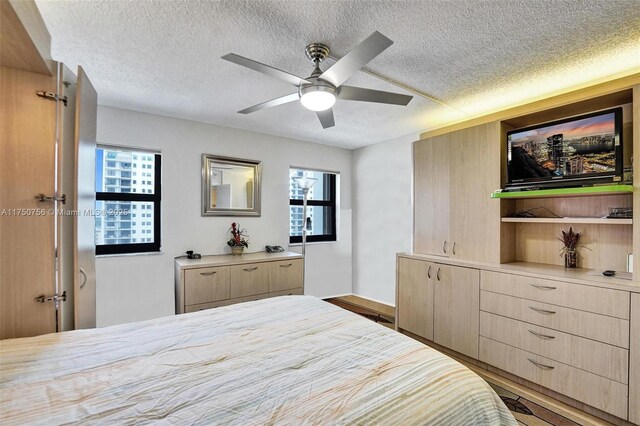 1201 S Ocean Dr Unit 1711S, Hollywood, FL 33019 - bedroom with a ceiling fan, a textured ceiling, and wood finished floors