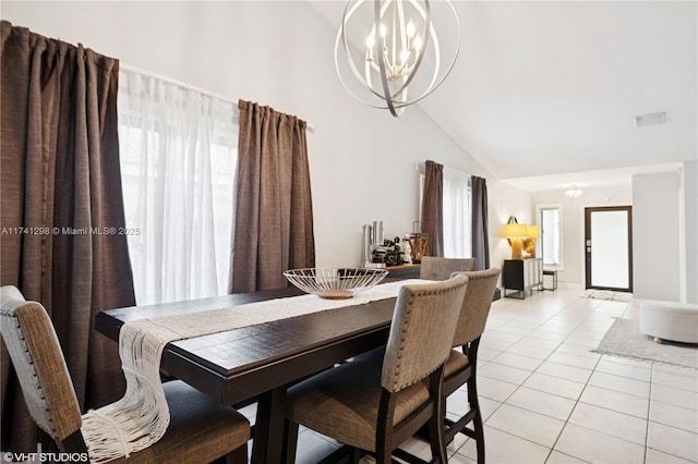 dining room featuring light tile patterned floors, a notable chandelier, and high vaulted ceiling