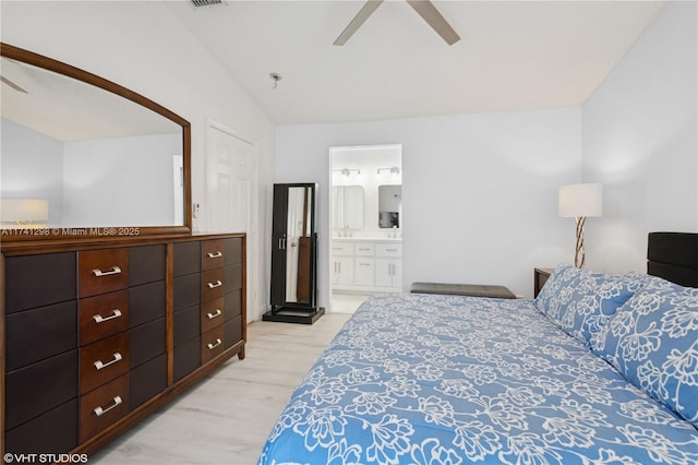 bedroom featuring ensuite bath, a ceiling fan, visible vents, and light wood finished floors