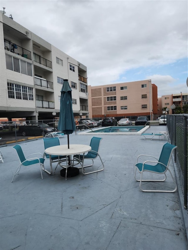 view of swimming pool featuring fence