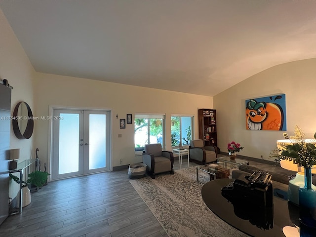 living area with lofted ceiling, french doors, wood finished floors, and baseboards