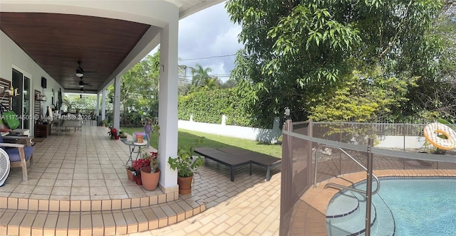 view of patio with ceiling fan, fence, and a fenced in pool