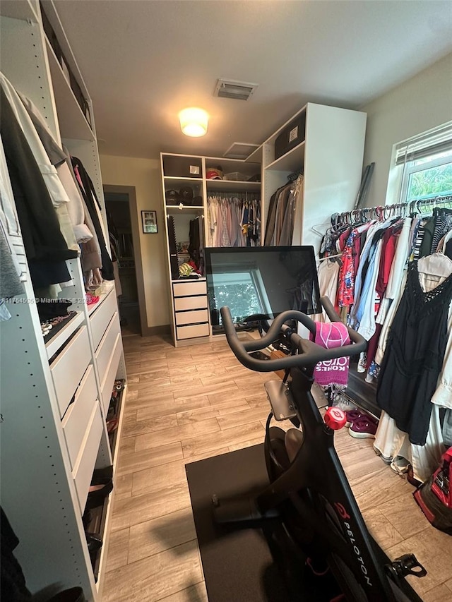 walk in closet with light wood-type flooring and visible vents