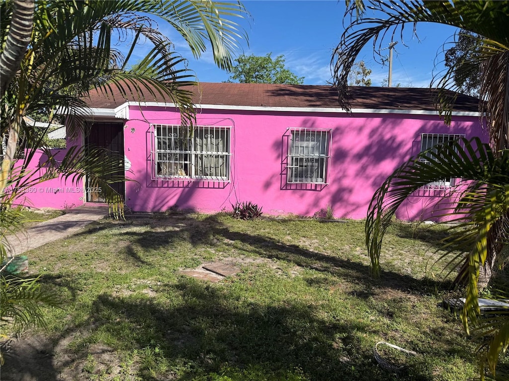 view of side of home featuring a yard