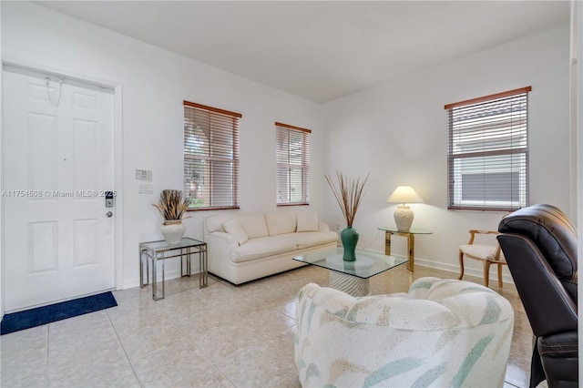 living room with light tile patterned flooring and baseboards