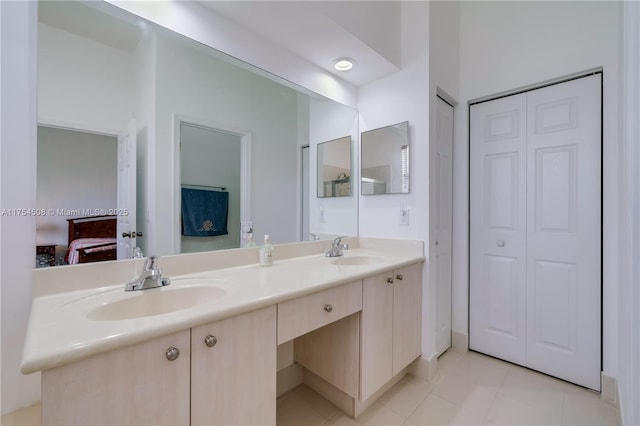 full bathroom with double vanity, ensuite bath, a closet, and a sink